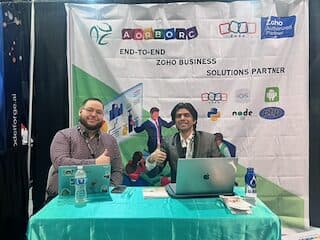 AorBorC Technologies booth at The Business Show, Las Vegas — full Zoho Authorized Partner banner behind the team.